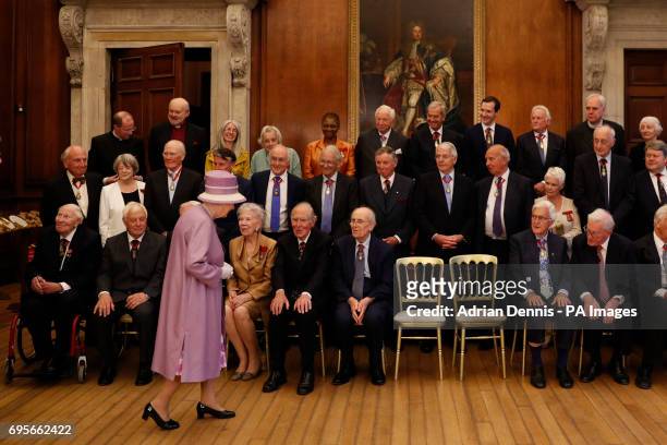 Queen Elizabeth II arrives for a photo with Companions of Honour after a reception in celebration of the centenary of the Order of the Companions of...
