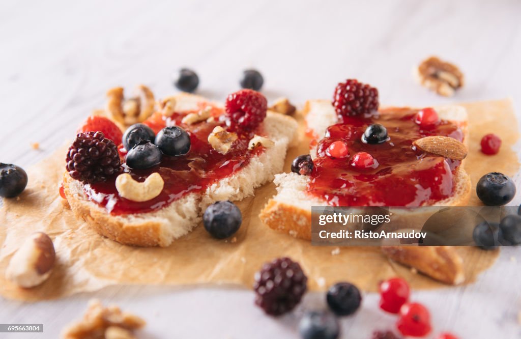 Close-up of toast with homemade strawberry jam on table - Stock image...