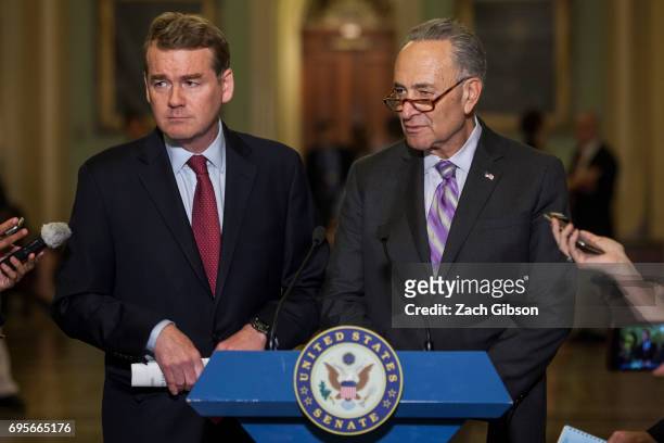 Sen. Michael Bennet , left, and Senate Minority Leader Chuck Schumer are pictured during a weekly press conference following a policy luncheon on...