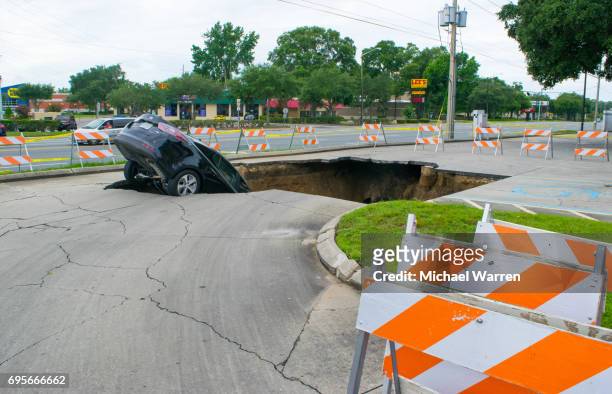 large sinkhole swallows a car in florida - florida sinkhole stock pictures, royalty-free photos & images