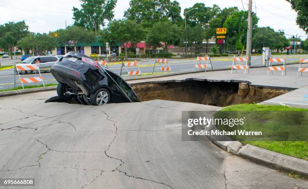 sinkhole swallows a car in florida - poço natural imagens e fotografias de stock