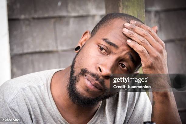 concerned afro caribbean man - afro caribbean and american stock pictures, royalty-free photos & images