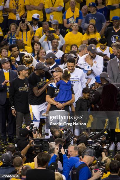 Finals: Golden State Warriors Stephen Curry victorious, holding daughter Riley after winning series vs Cleveland Cavaliers at Oracle Arena. Game 5....