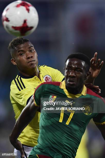 Cameroon's midfielder Arnaud Djoum vies with Colombia's midfielder Wilmar Barrios during the friendly football match Cameroon vs Colombia at the Col....