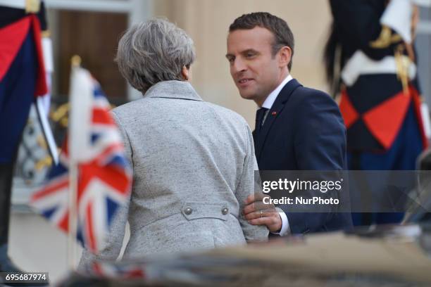 French President Emmanuel Macron welcomes British PM, Theresa May, as she arrives at The Élysée Palace . On Tuesday, June 13 in Paris, France.