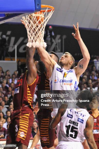 Melvin Ejim and Esteban Batista of Umana competes with Luca Lechthaler and Joao Gomes of Dolomiti during the match game 2 of play off final series of...