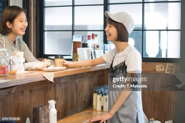 good friends talk in cafe - retail occupation ストックフォトと画像