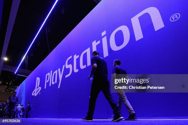 Game enthusiasts and industry personnel walk past the 'Sony Playstation' exhibit during the Electronic Entertainment Expo E3 at the Los Angeles...