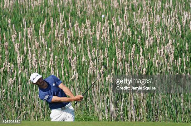 Dustin Johnson of the United States plays his shot during a practice round prior to the 2017 U.S. Open at Erin Hills on June 13, 2017 in Hartford,...
