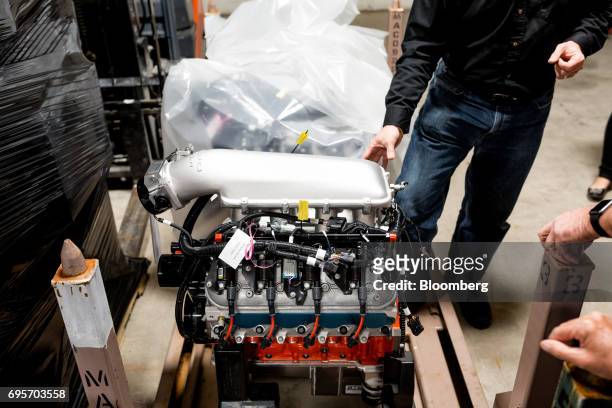 Tour attendees view a General Motors Co. Chevrolet COPO Camaro performance engine inside the company's build center in Oxford, Michigan, U.S., on...