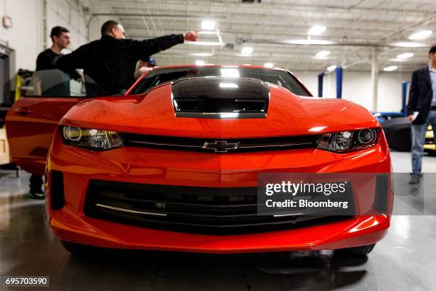 Tour attendees view a General Motors Co. Chevrolet COPO Camaro inside the company's build center in Oxford, Michigan, U.S., on Friday, April 21,...
