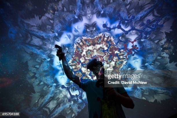 Man tries out a Virtual Reality game inside a Fulldome.pro 360-degree projection dome on opening day of the Electronic Entertainment Expo at the Los...