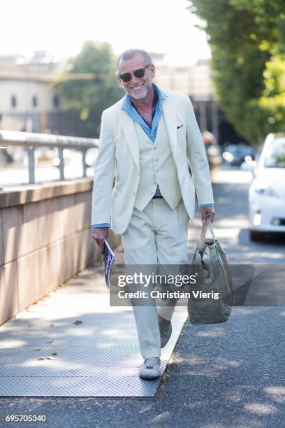 Alessandro Squarzi wearing a creme suit, weekender bag is seen during Pitti Immagine Uomo 92. At Fortezza Da Basso on June 13, 2017 in Florence,...