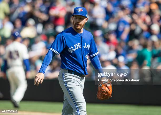 Relief pitcher Danny Barnes of the Toronto Blue Jays walks off the field after being pulled from a game against the Seattle Mariners at Safeco Field...