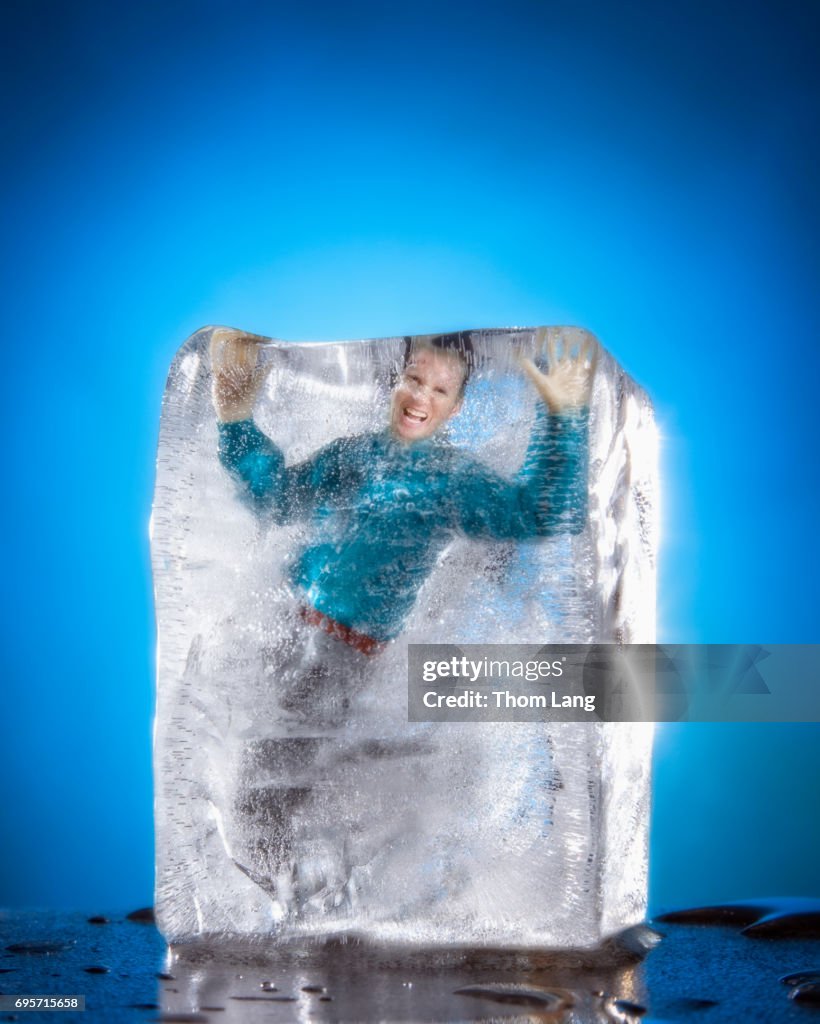 Man In Ice Man Frozen In Ice A Man Walking Across A Frozen Lake Holding A