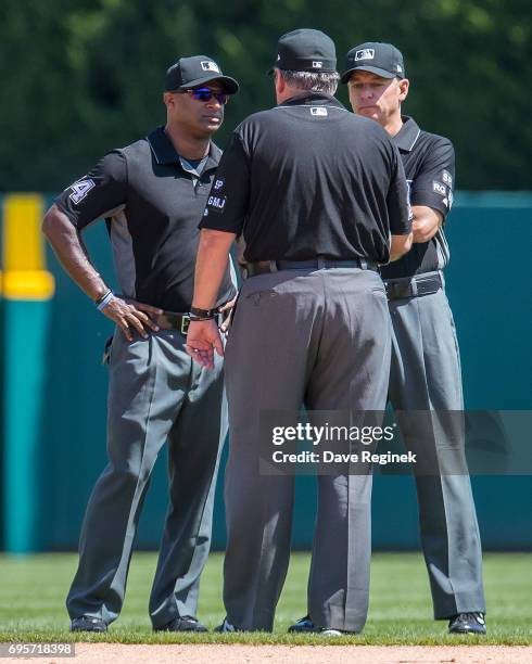 From left to right third base umpires Alan Porter, first base, Hunter Wendelstedt and second base, Andy Fletcher chat between the sixth inning during...