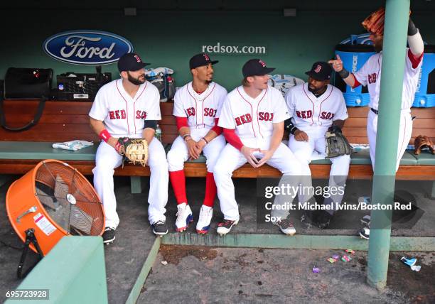 Mitch Moreland, Mookie Betts, Josh Rutledge, Jackie Bradley Jr. #19 and Dustin Pedroia of the Boston Red Sox talk on the bench before a game against...