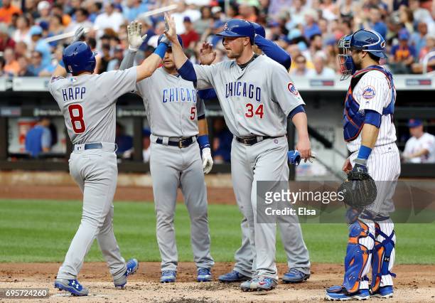 Ian Happ of the Chicago Cubs is congratulated by teammates Albert Almora Jr. #5,Anthony Rizzo and Jon Lester after Happ drove them all home with a...