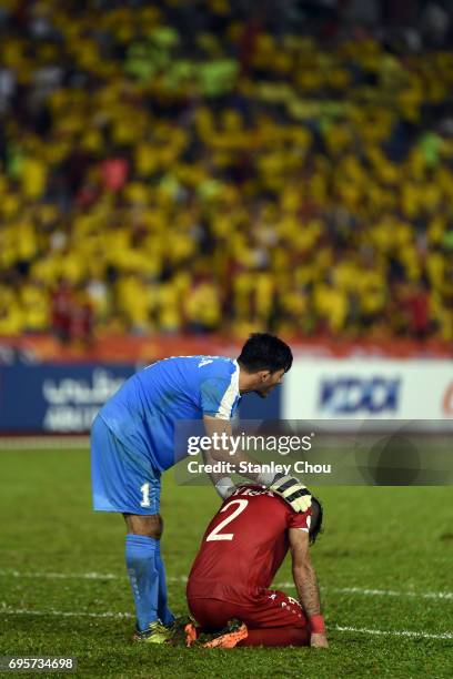 Ibrahim Alma goalkeeper of Syria consoles his compatriot Ahmad Al Saleh after the final whistle during the 2018 FIFA World Cup Asian Qualifier Group...