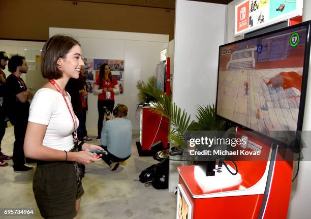 Actress Adelaide Kane plays Super Mario Odyssey at the Nintendo booth at the 2017 E3 Gaming Convention at Los Angeles Convention Center on June 13,...