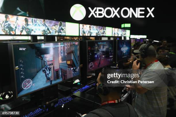 Gamers test 'Crackdown' on the XBox One X during the Electronic Entertainment Expo E3 at the Los Angeles Convention Center on June 13, 2017 in Los...