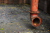 Colorful tube on dark sewage with dirty water