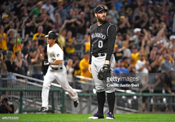 Adam Ottavino of the Colorado Rockies reacts as John Jaso of the Pittsburgh Pirates rounds the bases after hitting a two run home run in the seventh...