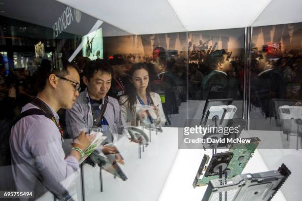 People look at X Box components on opening day of the Electronic Entertainment Expo at the Los Angeles Convention Center on June 13, 2017 in Los...