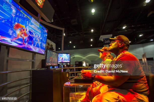 People play Ultra Street Fighter II: The Final Challengers on opening day of the Electronic Entertainment Expo at the Los Angeles Convention Center...