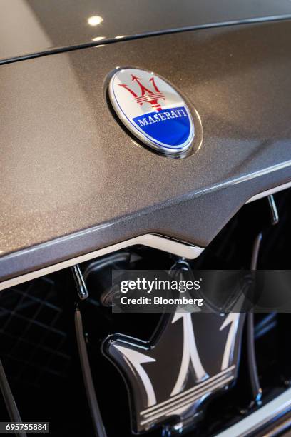 Maserati badge is seen on the hood of a Ghibli vehicle at a Maserati SpA showroom in Singapore on Sunday, June 4, 2017. Singapores economy may be...
