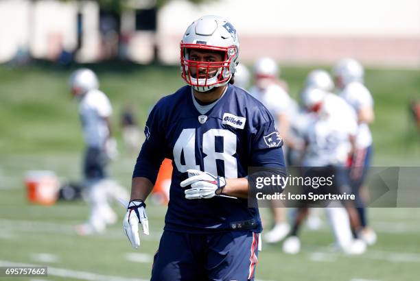 New England Patriots linebacker Harvey Langi warms up during New England Patriots OTA on June 13 at the Patriots Practice Facility in Foxborough,...