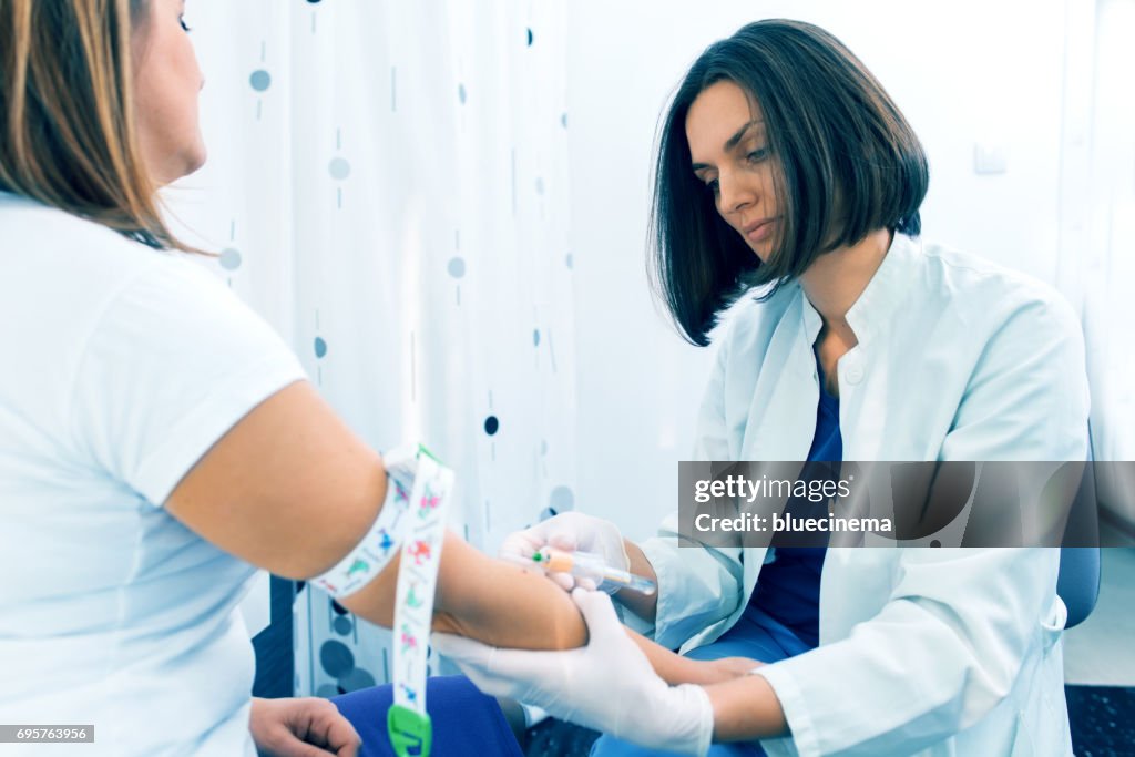 Nurse taking blood sample