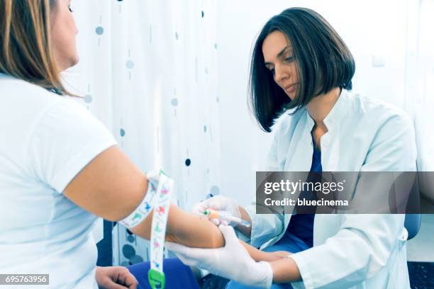 nurse taking blood sample - iv drip womans hand stock pictures, royalty-free photos & images