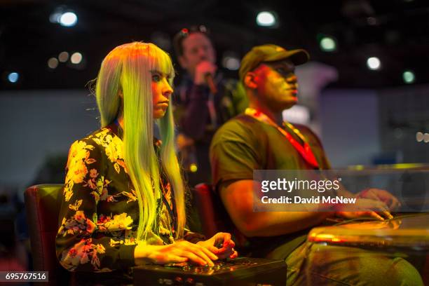 People compete at Ultra Street Fighter II: The Final Challengers on opening day of the Electronic Entertainment Expo at the Los Angeles Convention...