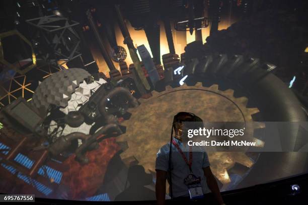 Man tries out a Virtual Reality game inside a Fulldome.pro 360-degree projection dome on opening day of the Electronic Entertainment Expo at the Los...