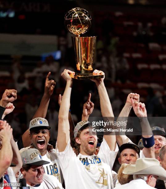 Dirk Nowitzki of the Dallas Mavericks holds the championship trophy after defeating the Miami Heat during Game 6 of the NBA Finals at the...