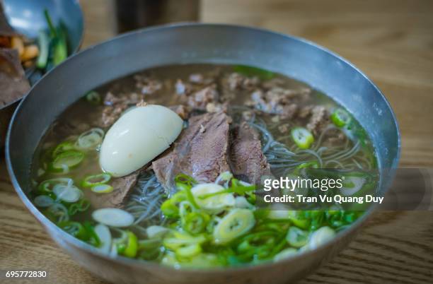 a bowl of korean hot noodles is on the table. - dried herring stock pictures, royalty-free photos & images