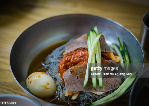 the korean cold noodle bowl is on the table. - dried herring stock pictures, royalty-free photos & images