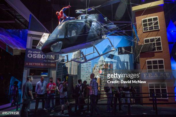 Marvel's Spider-Man character is seen atop a helicopter over people in the PlayStation exhibit area on opening day of the Electronic Entertainment...