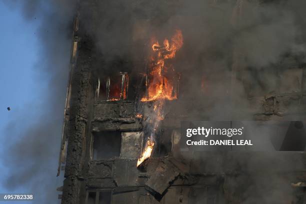Fire rips through Grenfell Tower as firefighters attempt to control a huge blaze on June 14, 2017 in west London. The massive fire ripped through the...