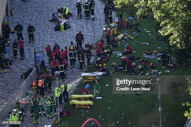 Fire fighters and emergency services gather at the building after a huge fire engulfed the 24 storey residential Grenfell Tower block in Latimer...