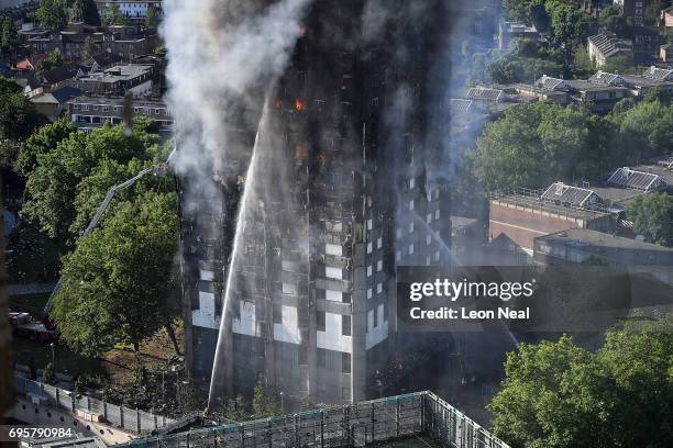 Fire fighters tackle the building after a huge fire engulfed the 24 storey residential Grenfell Tower block in Latimer Road, West London in the early...