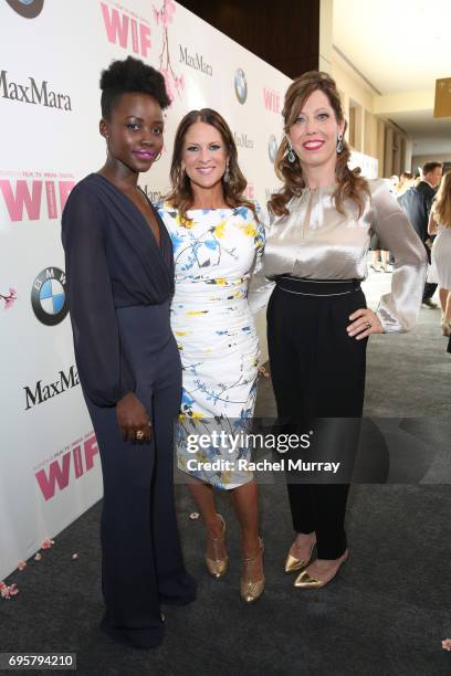 Actress Lupita Nyong'o, President of Women In Film Cathy Shulman, and WIF Executive Director Kirsten Schaffer, wearing Max Mara, at Women In Film...