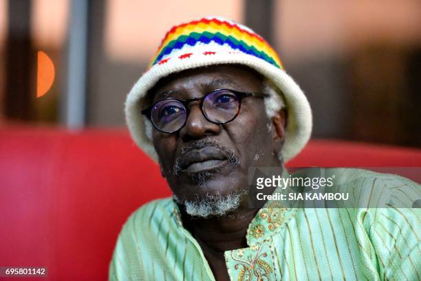 Ivorian reggae singer Alpha Blondy looks on during a an interview in Abidjan on June 14, 2017. / AFP PHOTO / Sia KAMBOU