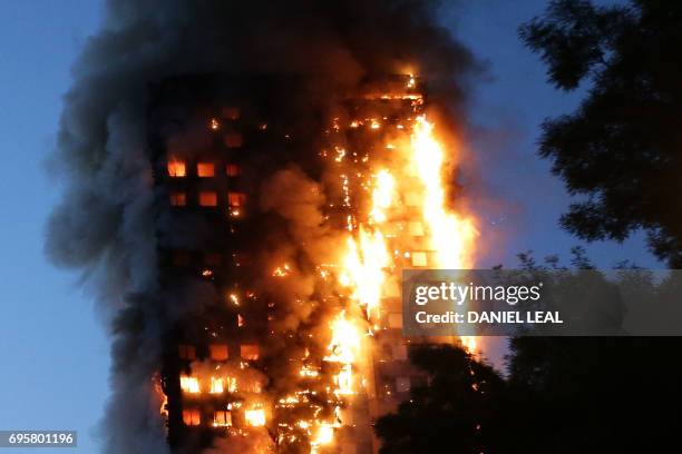 Fire engulfs Grenfell Tower, a residential tower block on June 14, 2017 in west London. The massive fire ripped through the 27-storey apartment block...