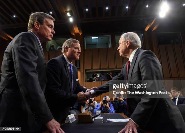 Attorney General Jeff Sessions, right, is greeted by Senate Intelligence Committee Chair Sen. Richard Burr, center, and Vice Chair Sen. Mark Warner...