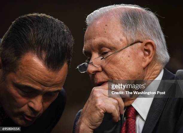 Attorney General Jeff Sessions talks with an aide as he testifies in an open hearing before the Senate Intelligence Committee, on June 2017 in...