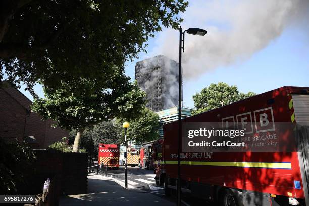 Fire brigade vehicles are parked near the 24 storey residential Grenfell Tower block in Latimer Road, West London in the early hours of this morning...