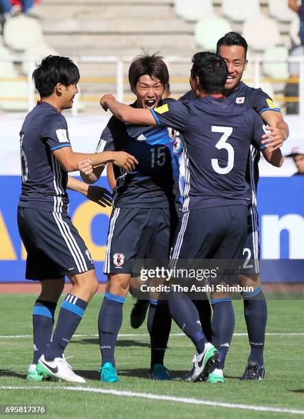 Yuya Osako of Japan celebrates scoring the opening goal with his team mates during the FIFA World Cup Russia Asian Final Qualifier match between Iraq...