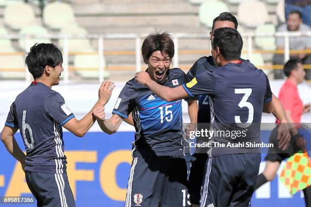 Yuya Osako of Japan celebrates scoring the opening goal with his team mates during the FIFA World Cup Russia Asian Final Qualifier match between Iraq...